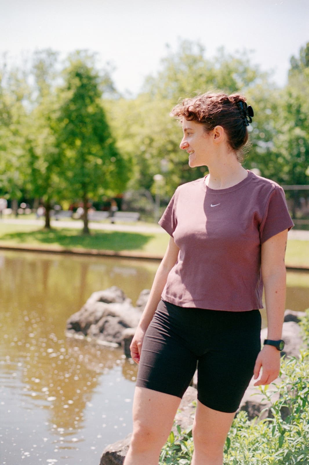 Vero smiling by a pond in an Amsterdam park